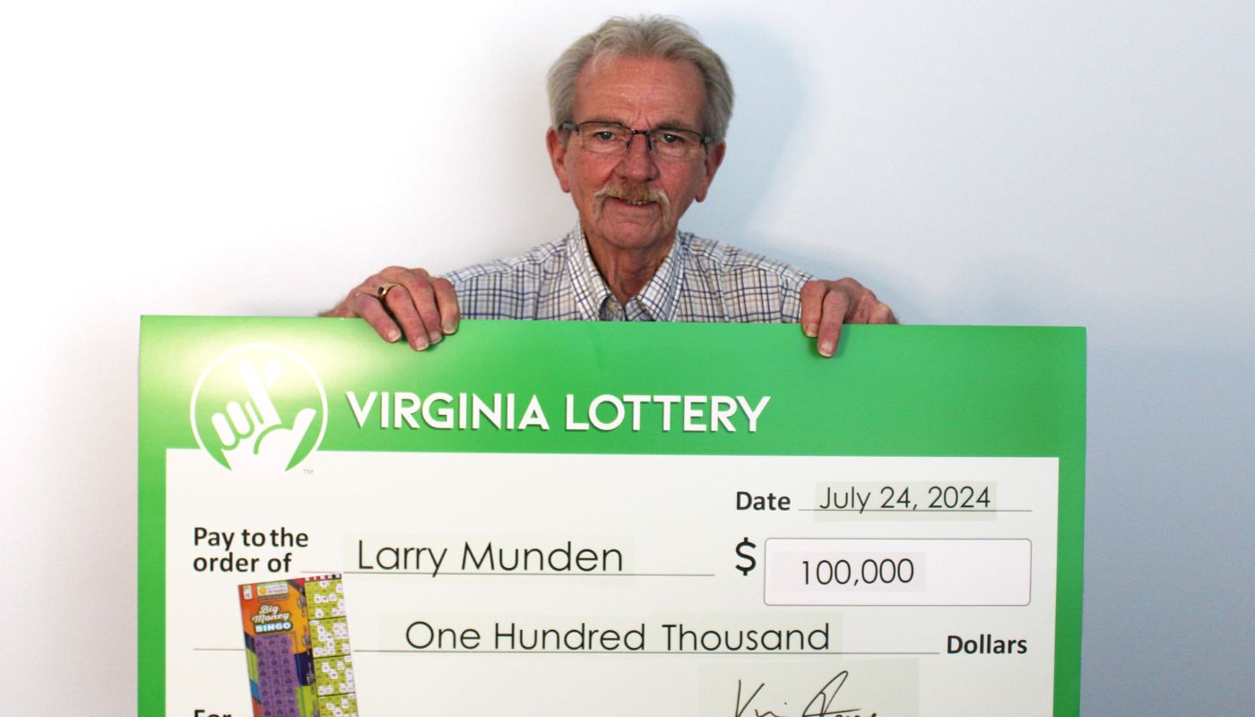 Larry Munden, Sr., holding his $100,000 Virginia Lottery check.