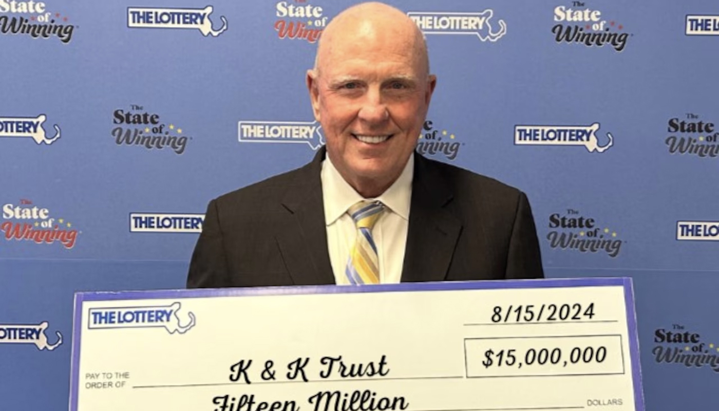 Leo Cushing, trustee of the K & K Trust of Waltham, holding the $15 million Massachusetts Lottery check.