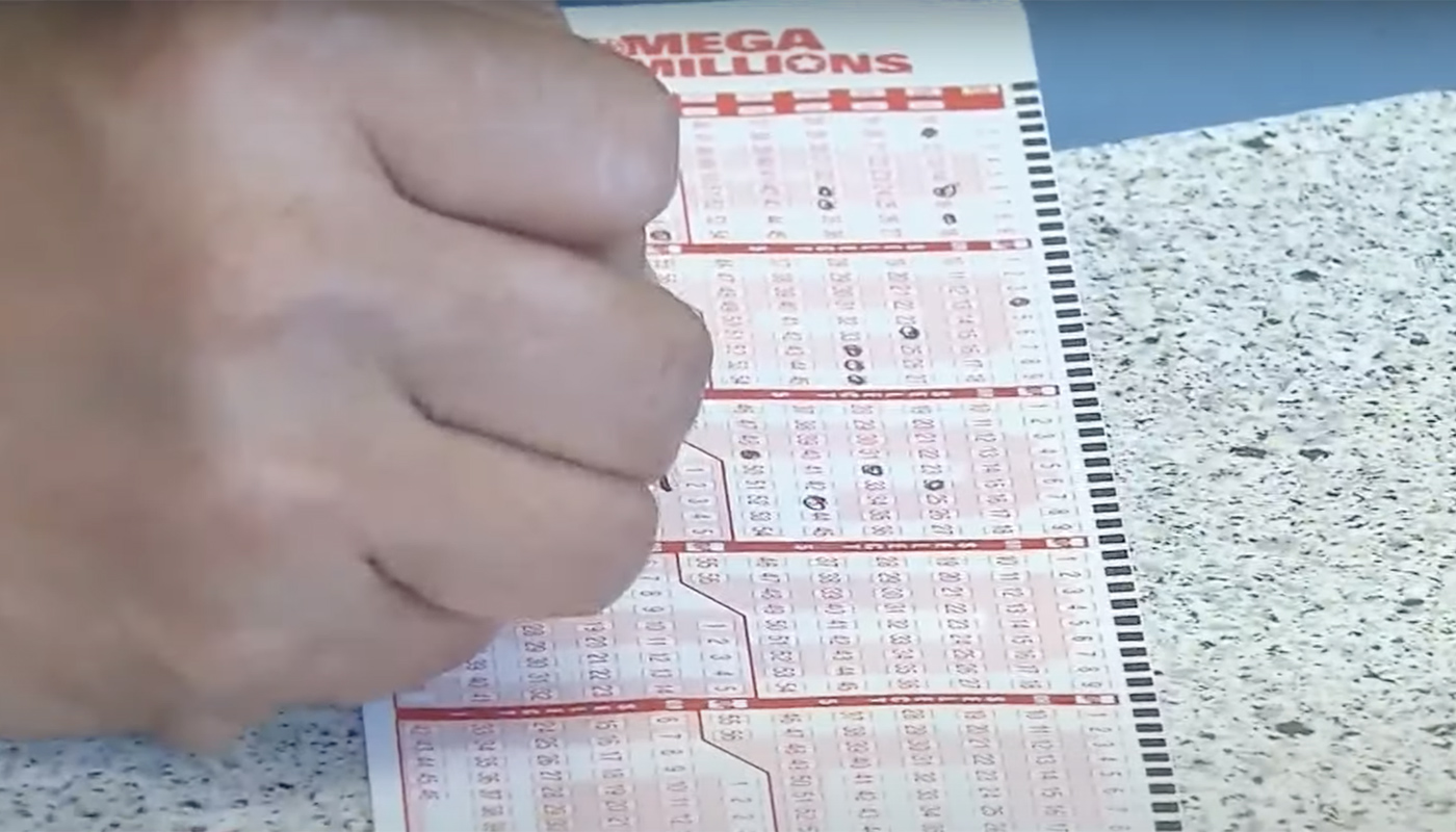 A California Lottery player using a play slip to play Mega Millions at a local retailer.