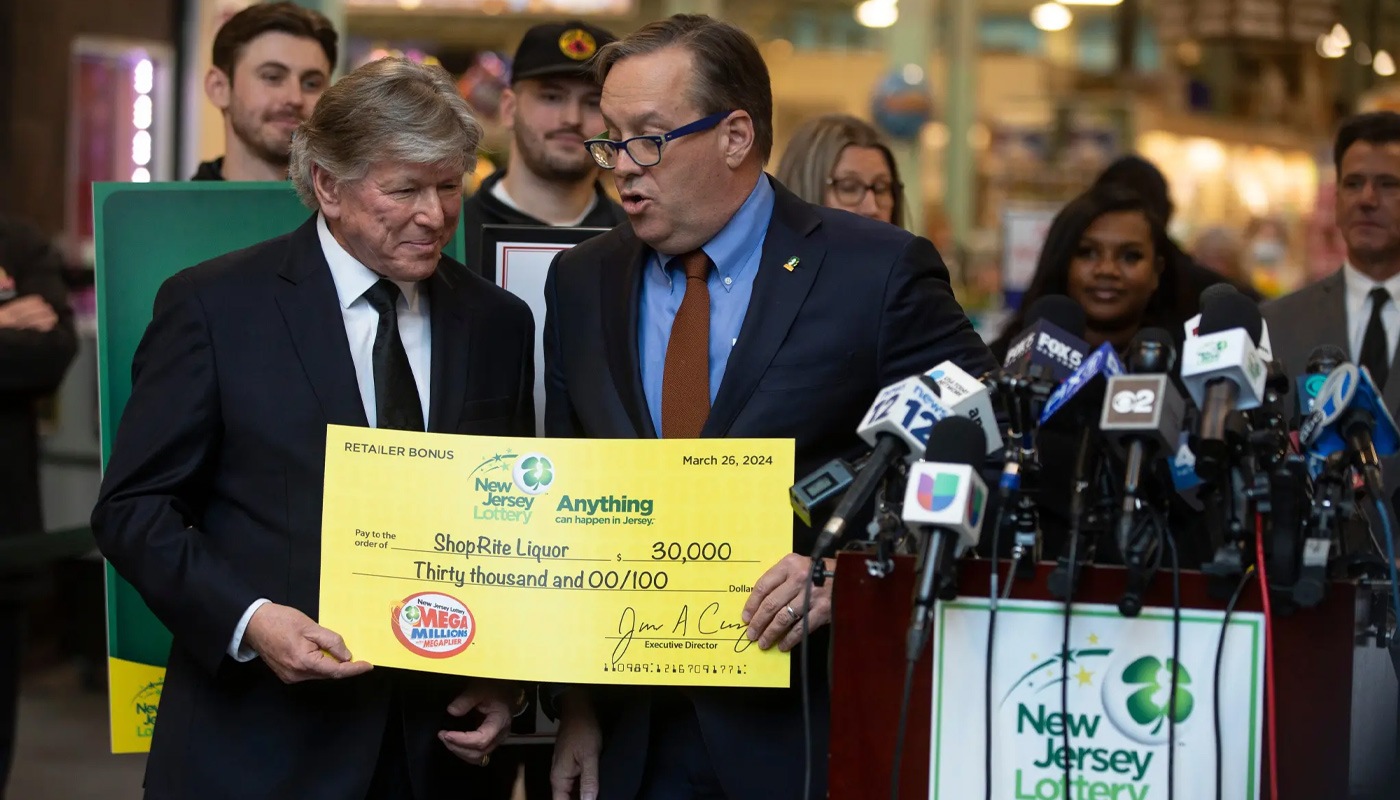 Richard Saker, owner of the ShopRite store that sold the $1.13 billion winning Mega Millions ticket, receiving the bonus commission check from the New Jersey Lottery.