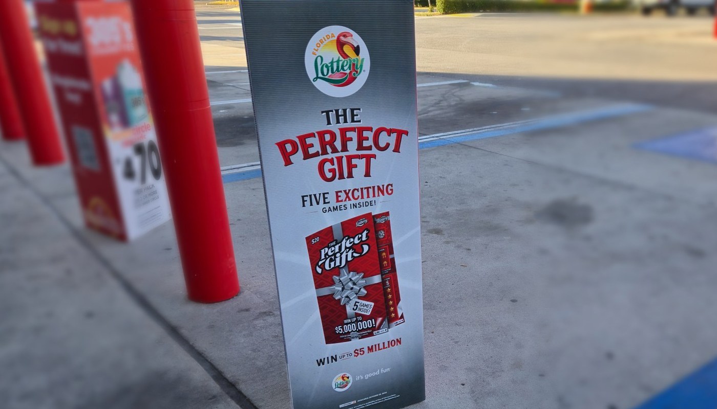 A Florida Lottery sign promoting scratch-off tickets as the perfect Christmas gift.