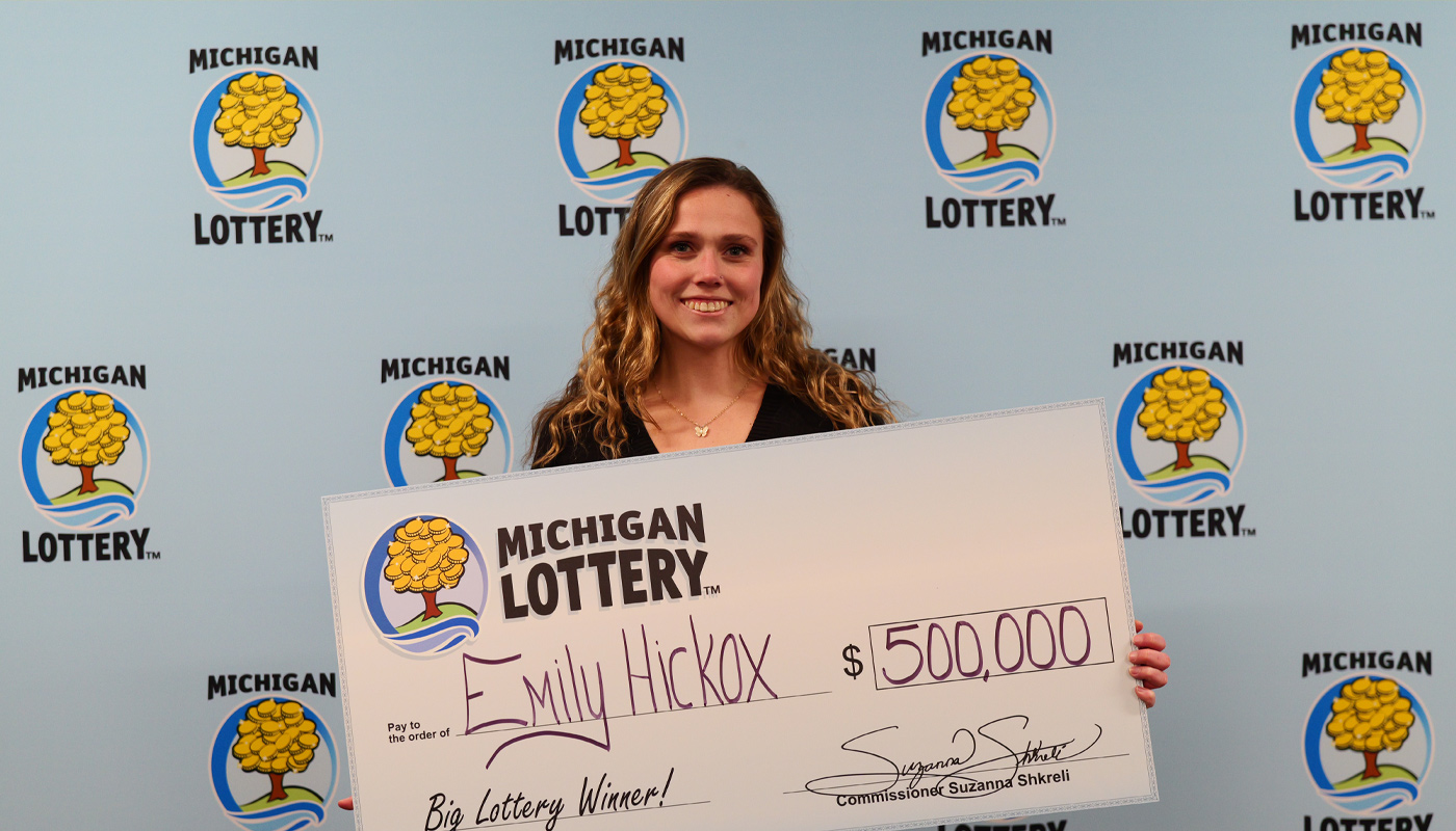 Emily Hickox, holding her $500,000 Michigan Lottery check.