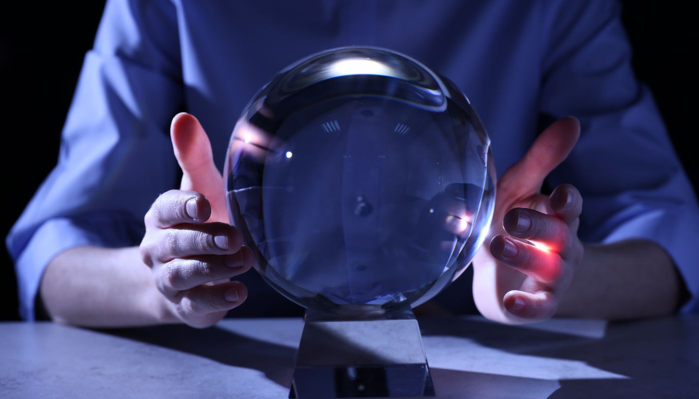 A photograph of two hands holding a crystal ball.