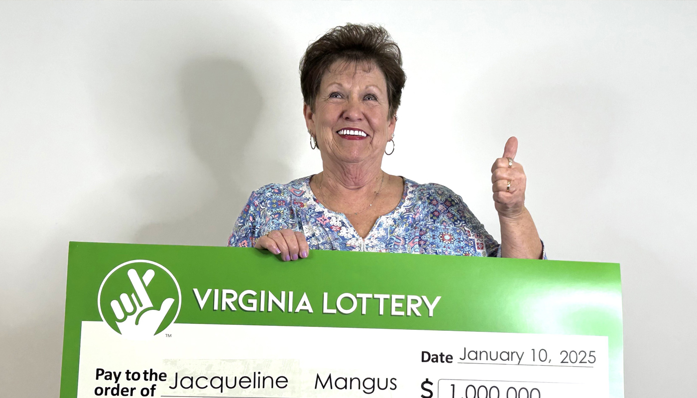 Jacqueline Mangus, holding the $1 million check she won after storing her lottery ticket in the Bible.