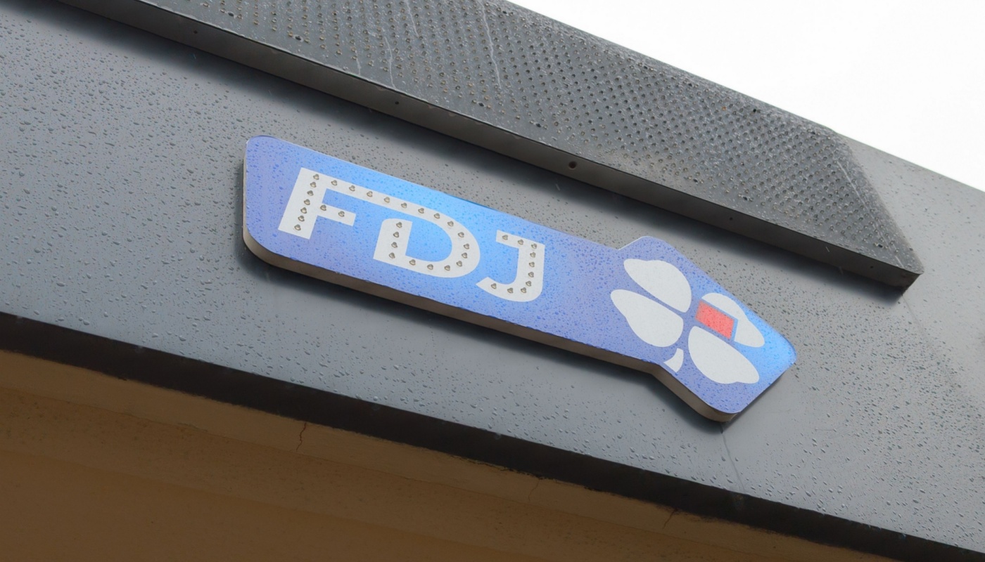 A La Française des Jeux (FDJ) sign on the side of a building.