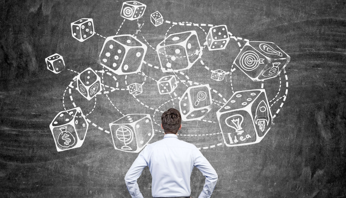 A person standing in front of a whiteboard with drawings depicting rolling dice.