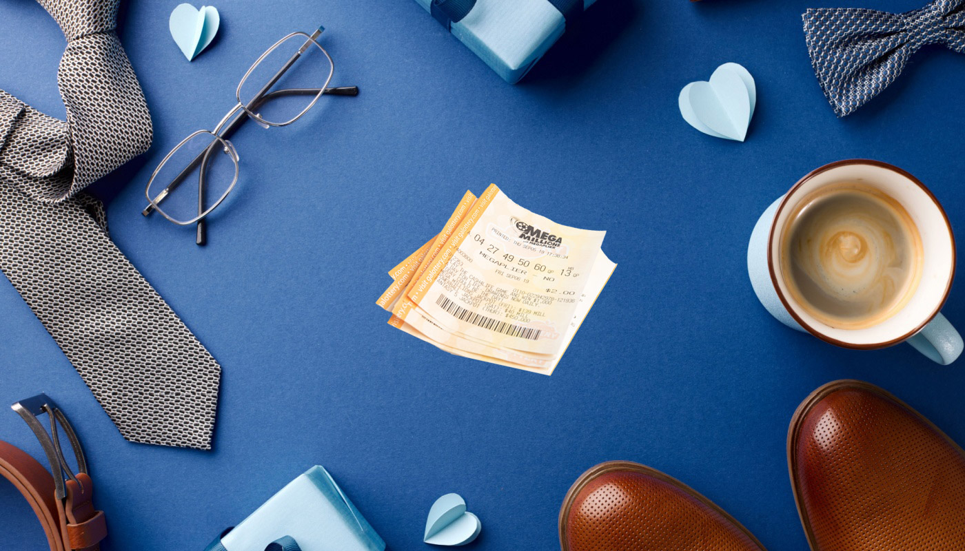 Some packaged gifts, Mega Millions tickets, a cup with coffee, glasses, a tie, and formal shoes on top of a blue surface.