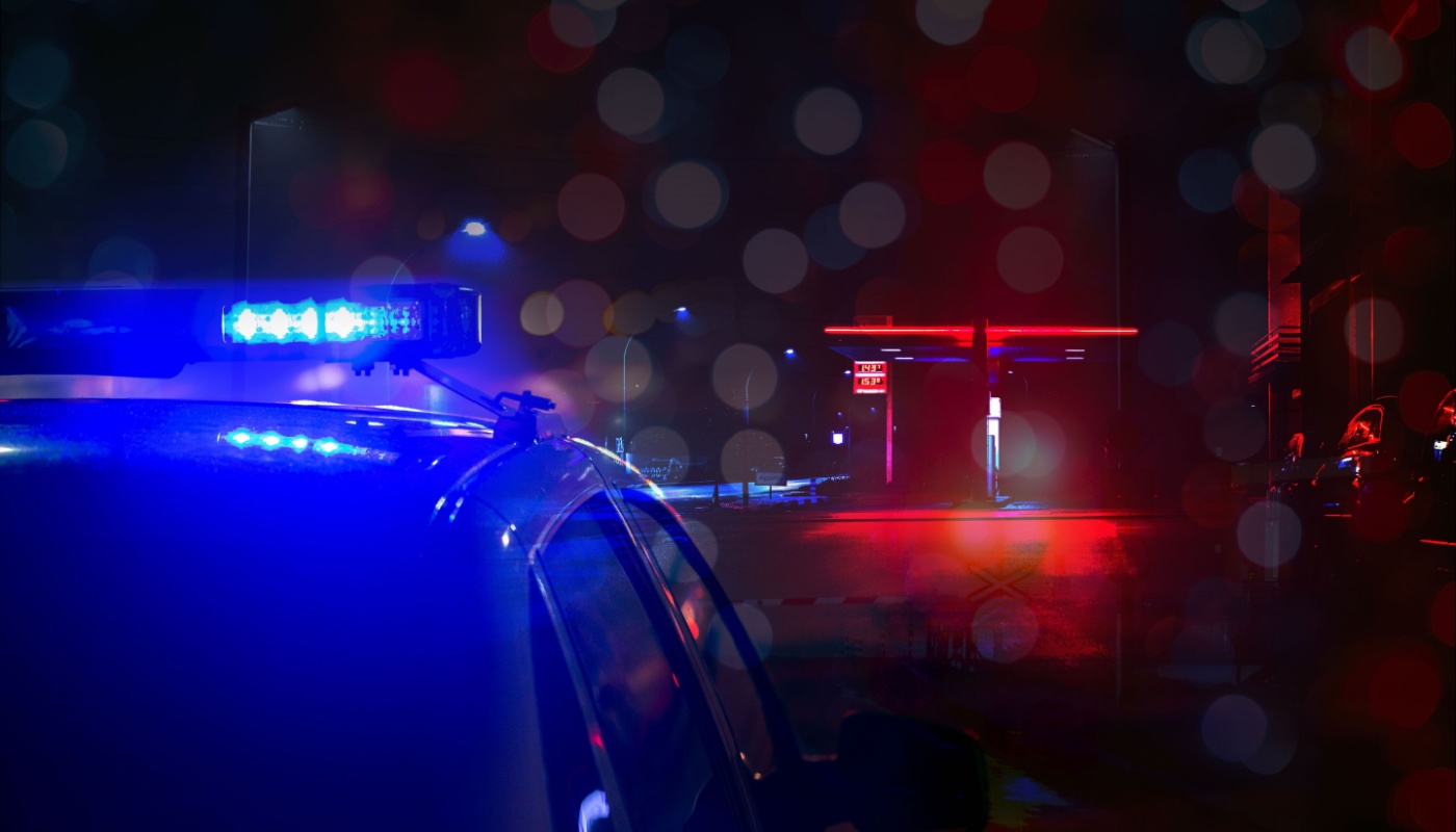 The lights of a police car during a rainy night.