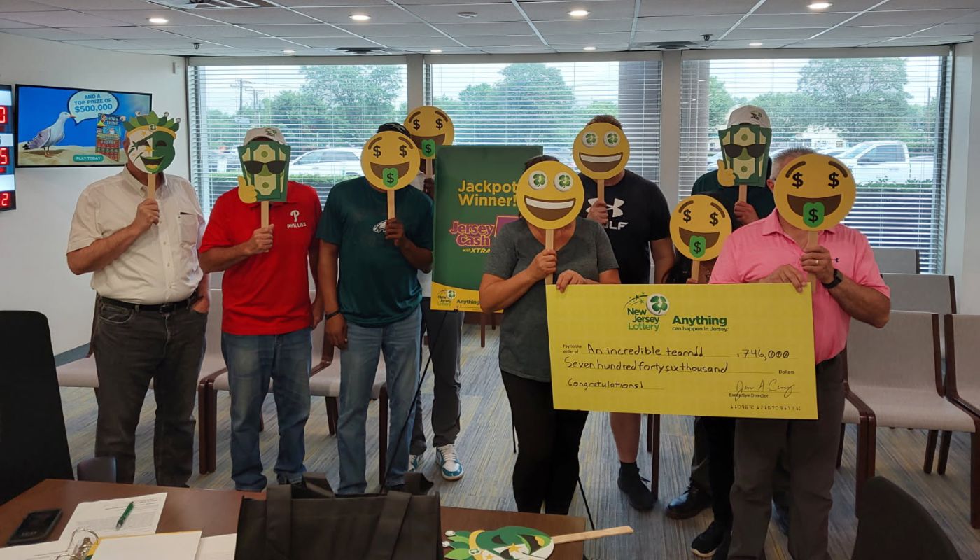 The nine Camden County winners holding their $746,853 Jersey Cash 5 Jackpot check.
