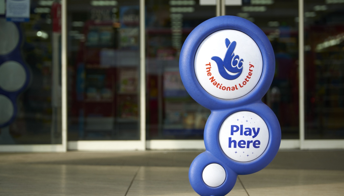 A National Lottery sign, outside of a lottery retailer in the UK.