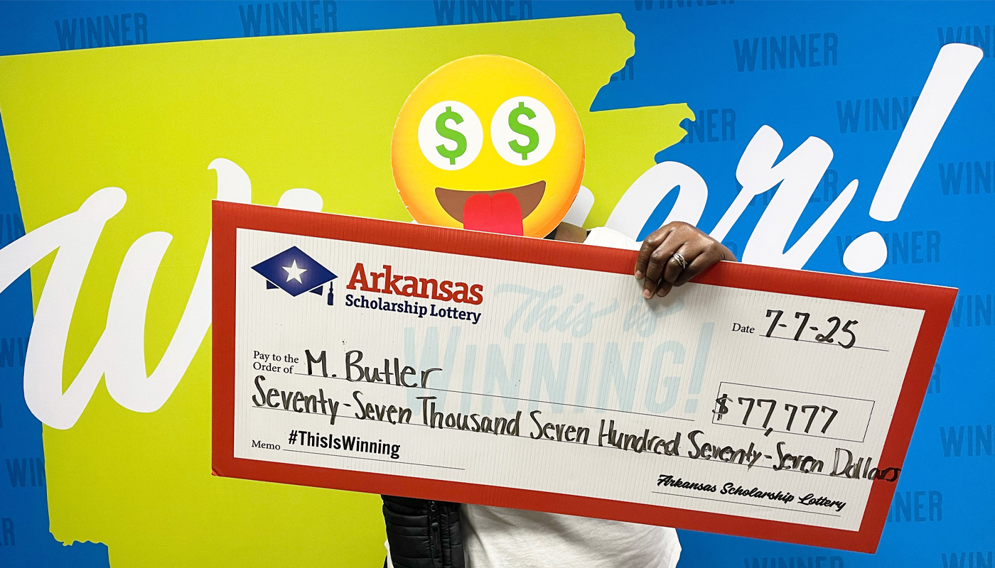 M. Butler, holding her $77,777 Arkansas Scholarship Lottery check.
