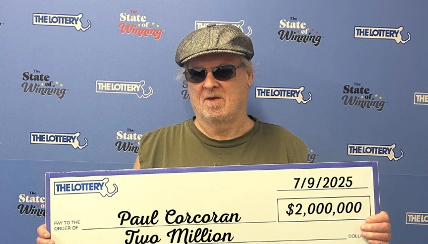 Paul Corcoran of Fitchburg, Massachusetts, holding his $2 million check.