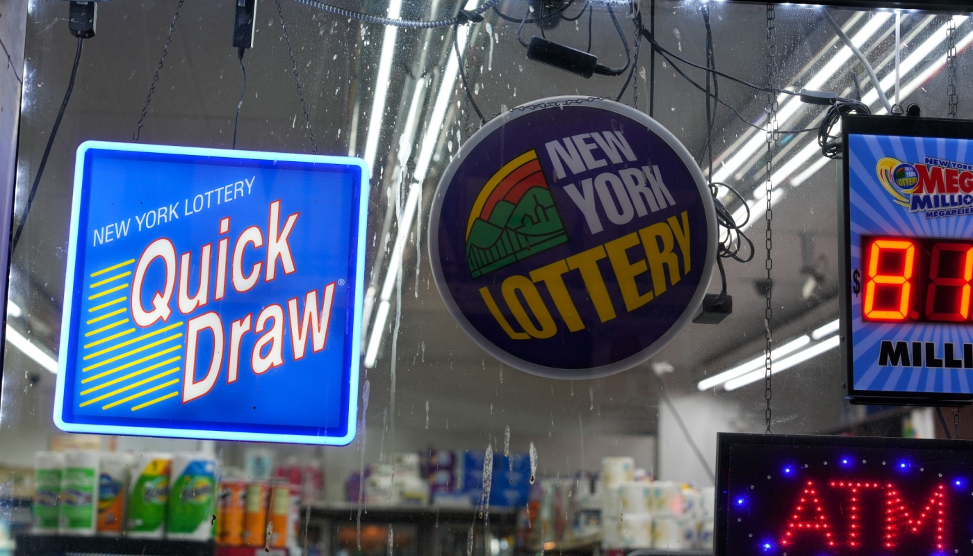 New York Lottery signs on the window of a lottery retailer.