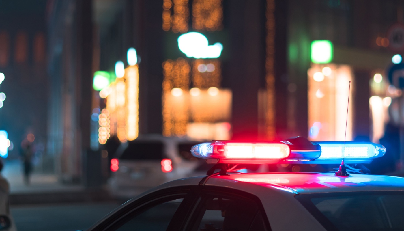 A close up of the lights on a cop car at night.