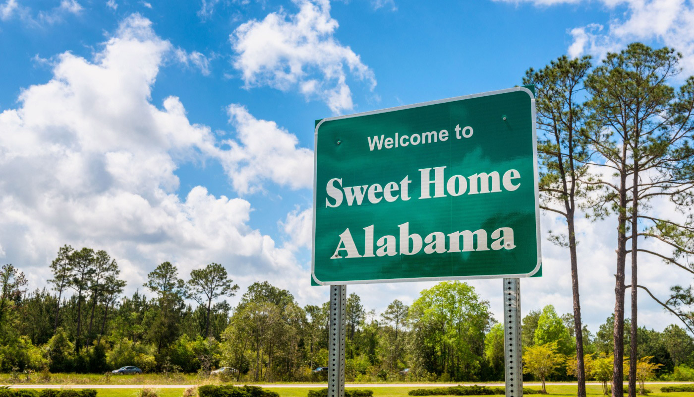 A "Welcome to Sweet Home Alabama" sign.
