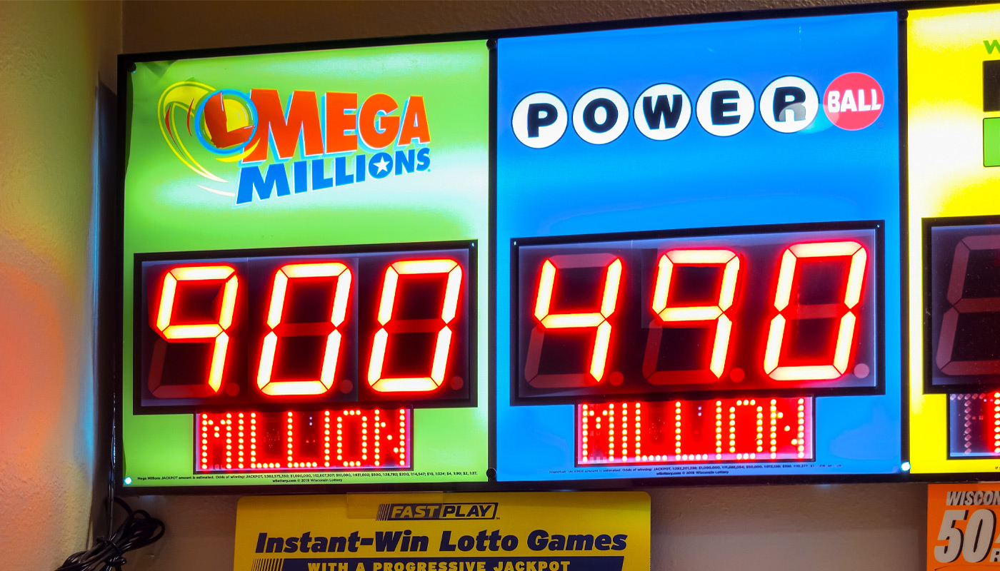 An electronic display with a $900 million Mega Millions jackpot and a $490 million Powerball jackpot.