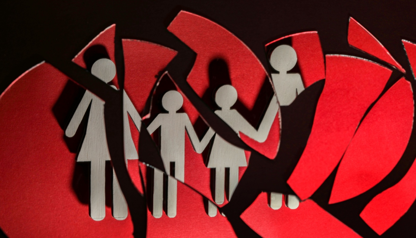 An image showing a paper representation of a family being broken up.