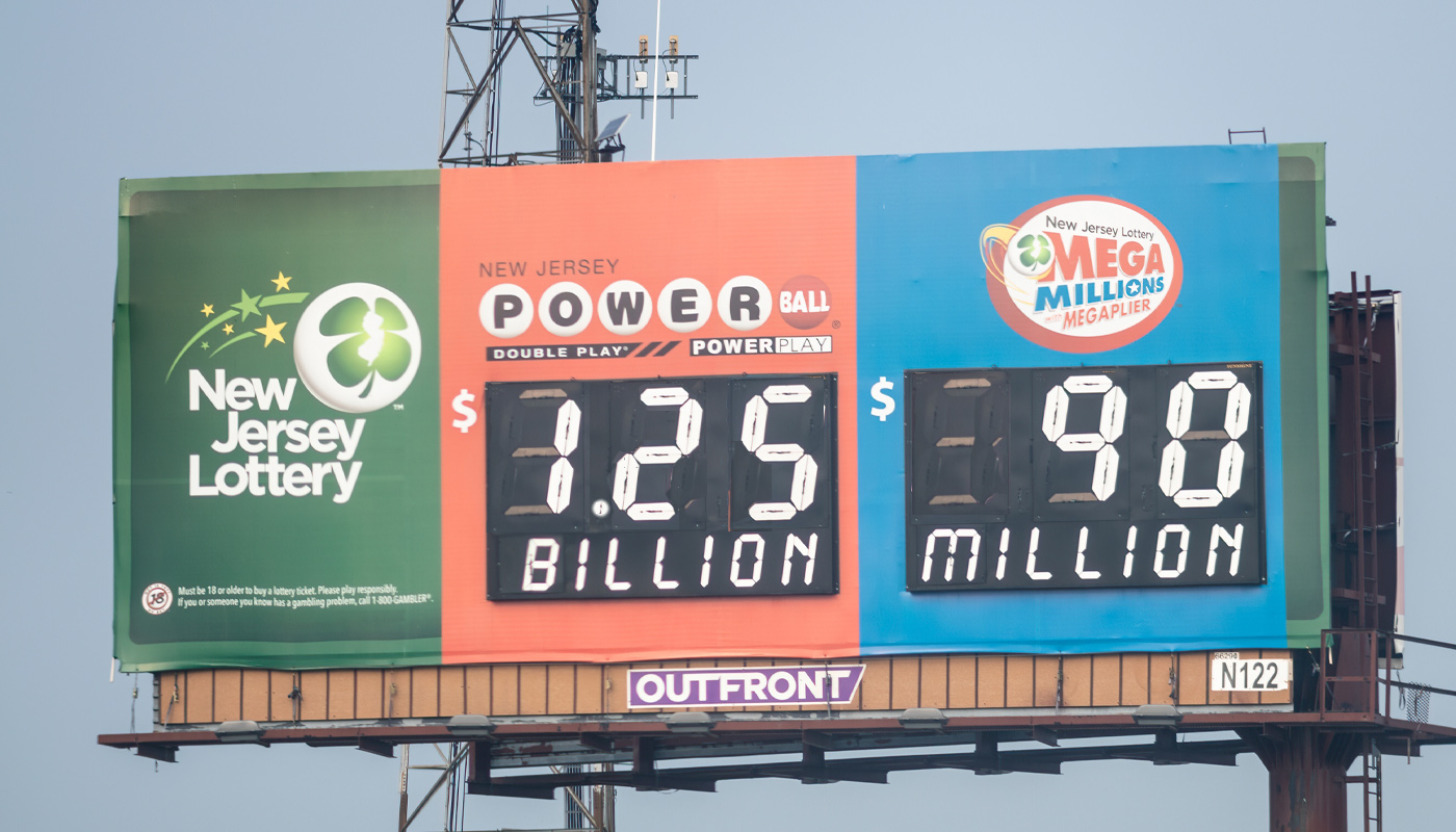 A New Jersey Lottery billboard displaying a $1.25 billion Powerball jackpot and a $90 million Mega Millions jackpot.