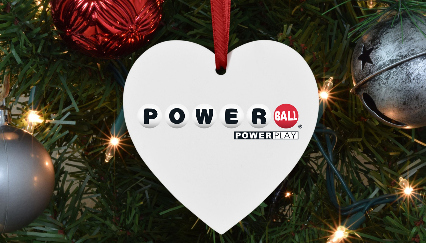 A Christmas ornament in the shape of a heart, with the Powerball logo.
