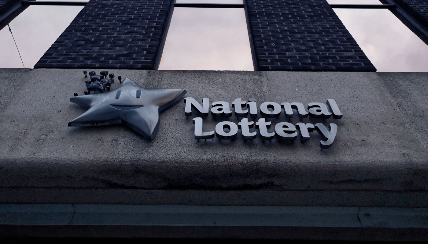 Ireland's National Lottery logo on a wall.
