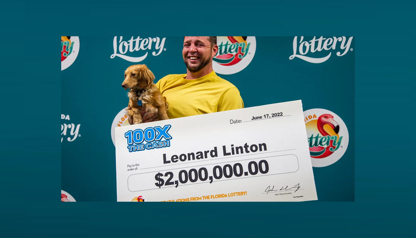 Florida Lottery winner Leonard Linton, with his $2 million check and his faithful companion Ivy.