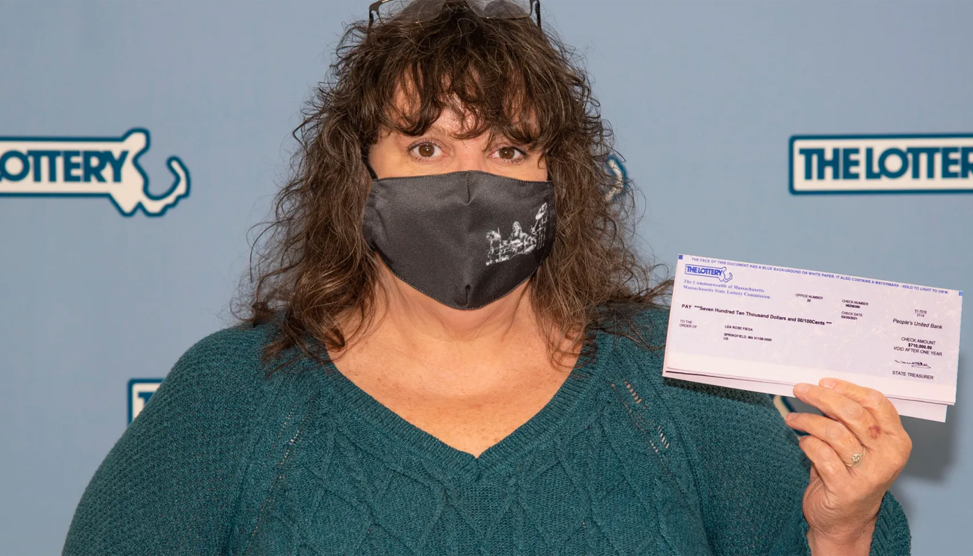 Lea Rose Fiega, with her $1 million check from the Massachusetts Lottery.
