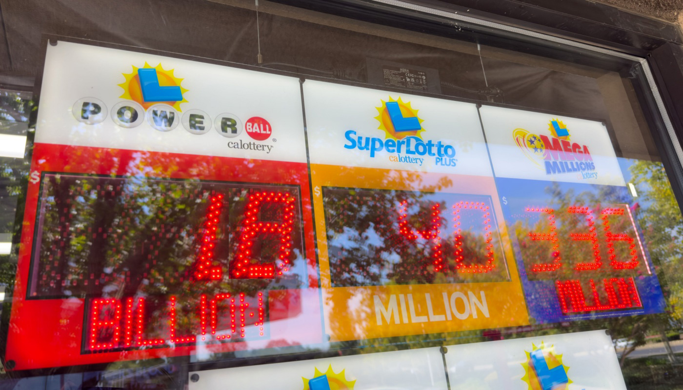 Signs at a retailer displaying the Powerball, Mega Millions, and California SuperLotto Plus jackpots.