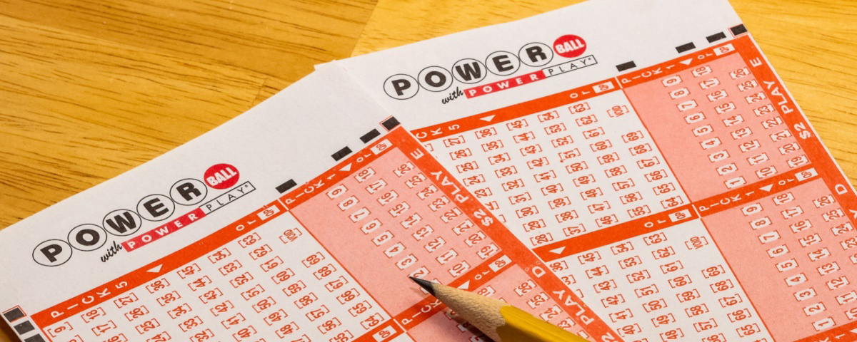 Two Powerball play slips and a pencil.