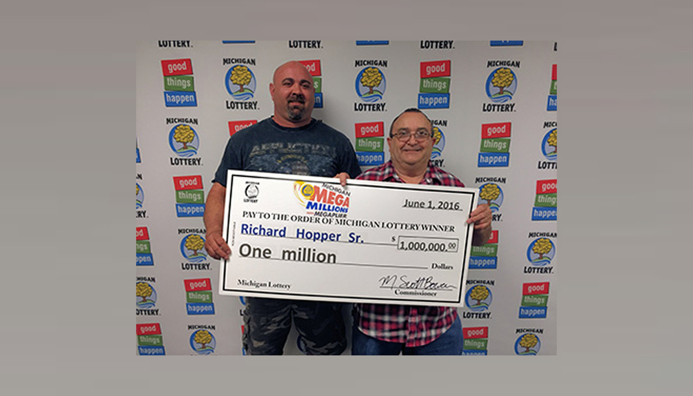Richard Hopper Sr with his $1,000,000 Michigan Lottery check.