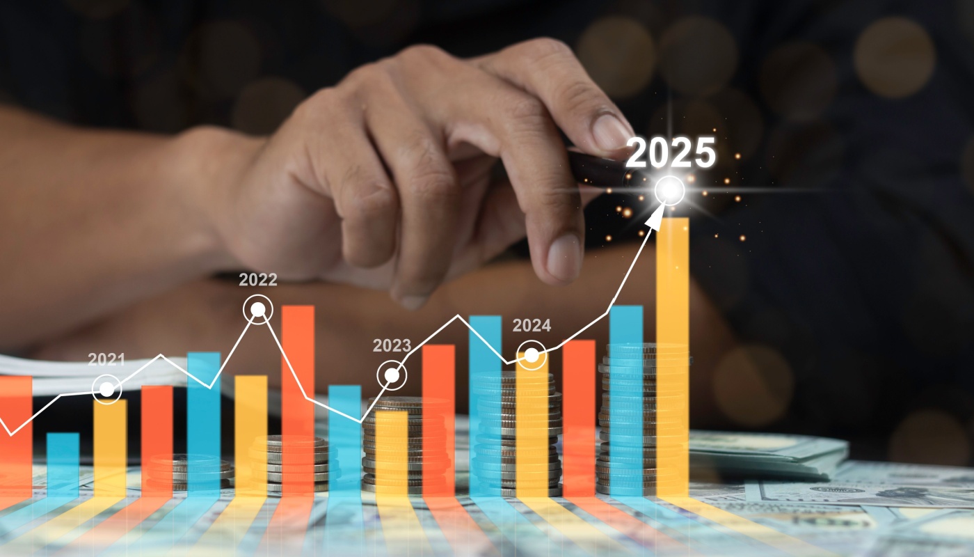 A hand drawing a graph encompassing multiple years that shows a spike in stats for 2025.