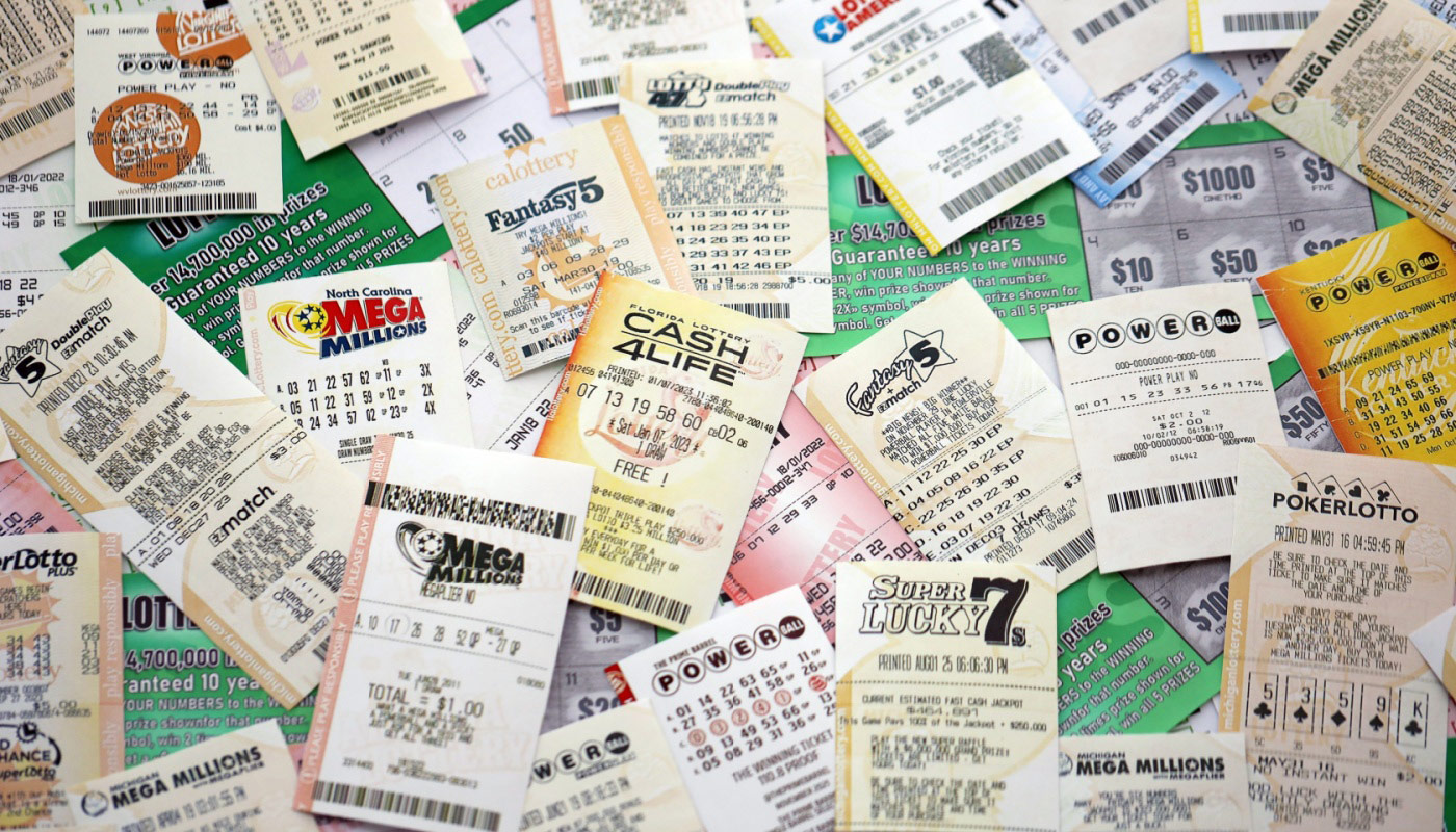 A bunch of lottery tickets and scratch-offs spread over a table.