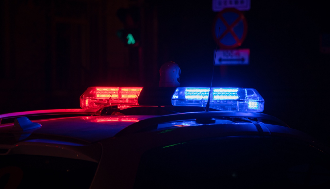 The flashing lights of a police car at night.