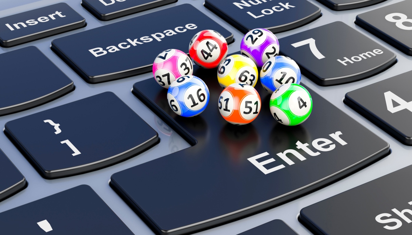 Lottery balls on top of the "Enter" key on a computer keyboard.