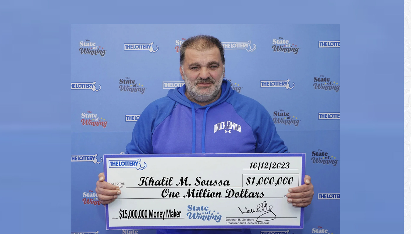 Khalil Soussa of Medford, Massachusetts, with his $1 million Massachusetts Lottery check.