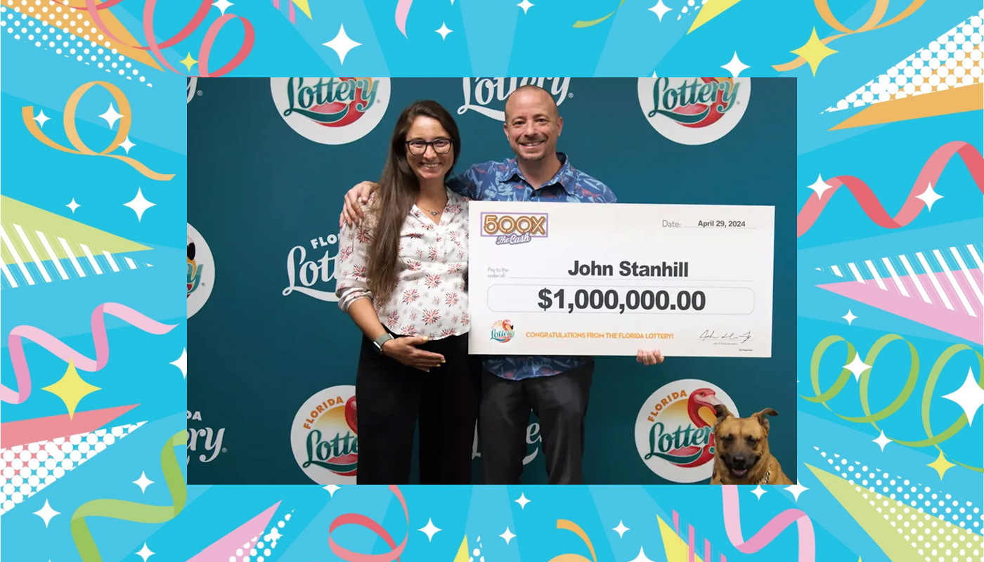John Stanhill and Victoria Oakley are seen holding their one-million-dollar check from the Florida Lottery.