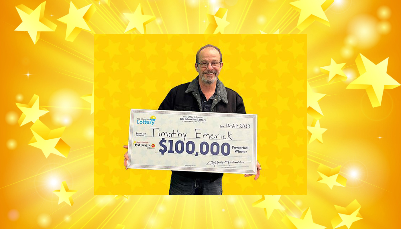 Timothy Emerick with one of his two $100,000 North Carolina Lottery checks.