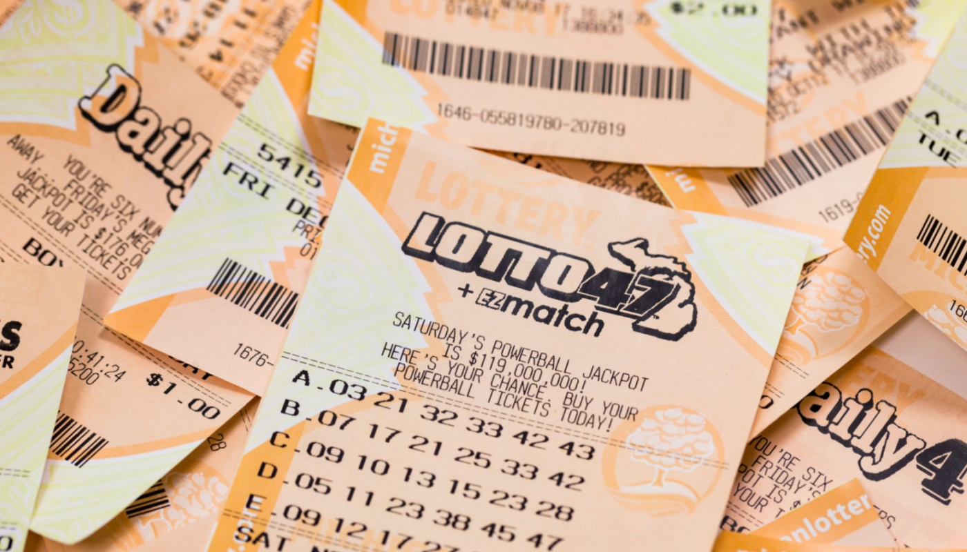 A Michigan Lottery Lotto 47 ticket on top of other lottery tickets.