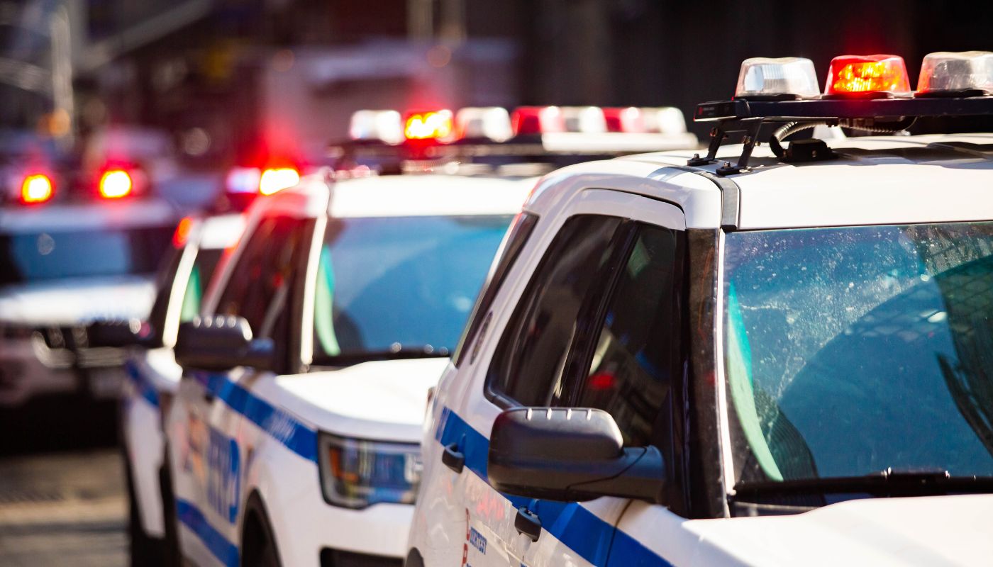A picture of police cars with their lights on.