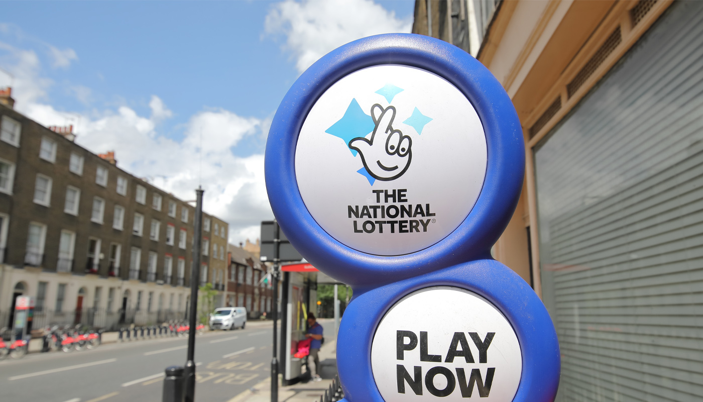 The UK National Lottery logo on a sign.