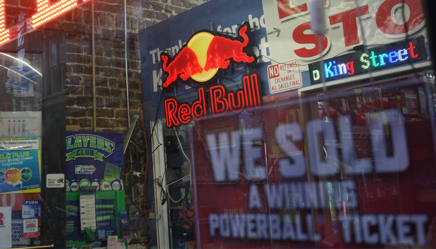 A "We sold a Powerball winning tickets" sign on a window.