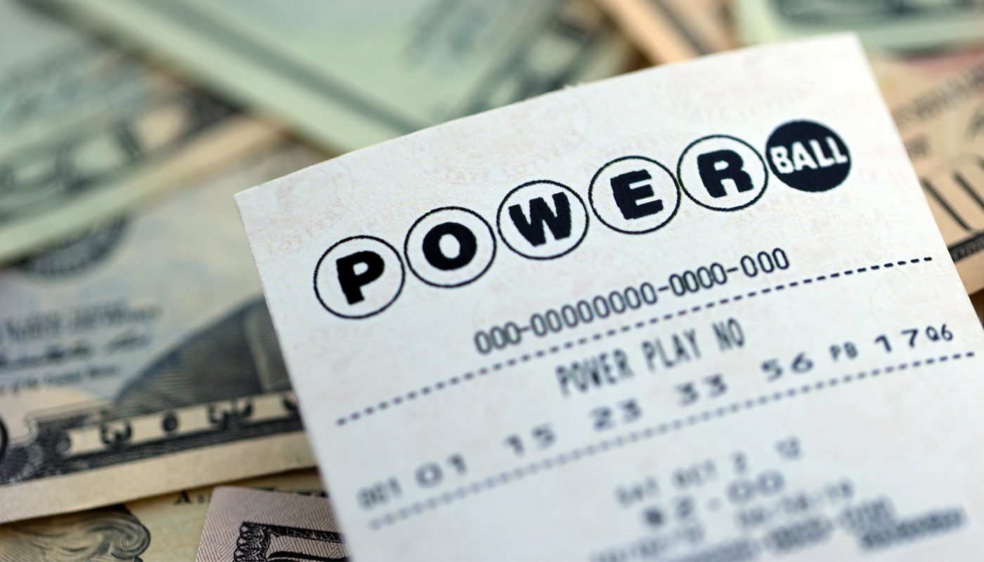A Powerball ticket on top of dollar bills.