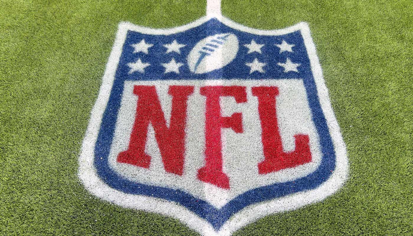The NFL logo printed on grass.
