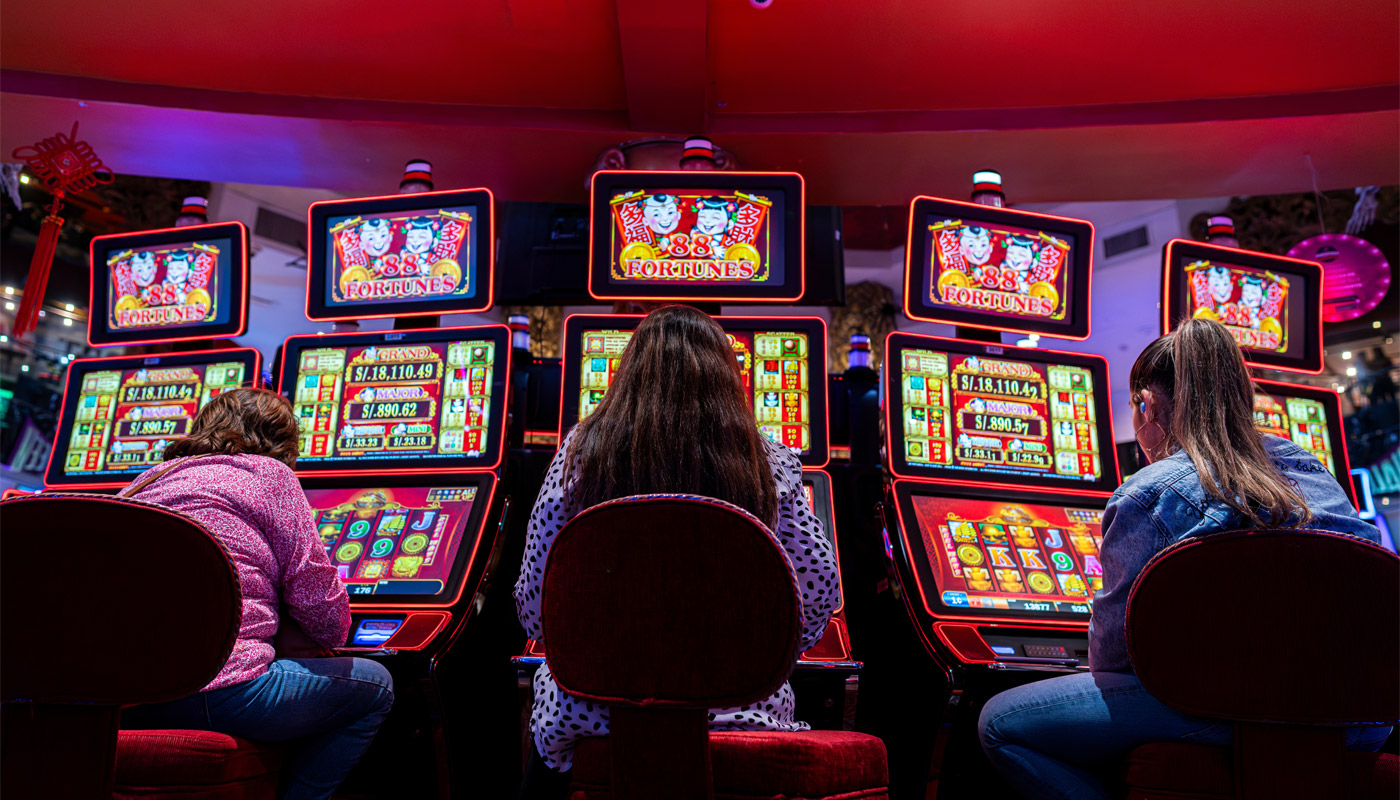People playing slots at a casino.