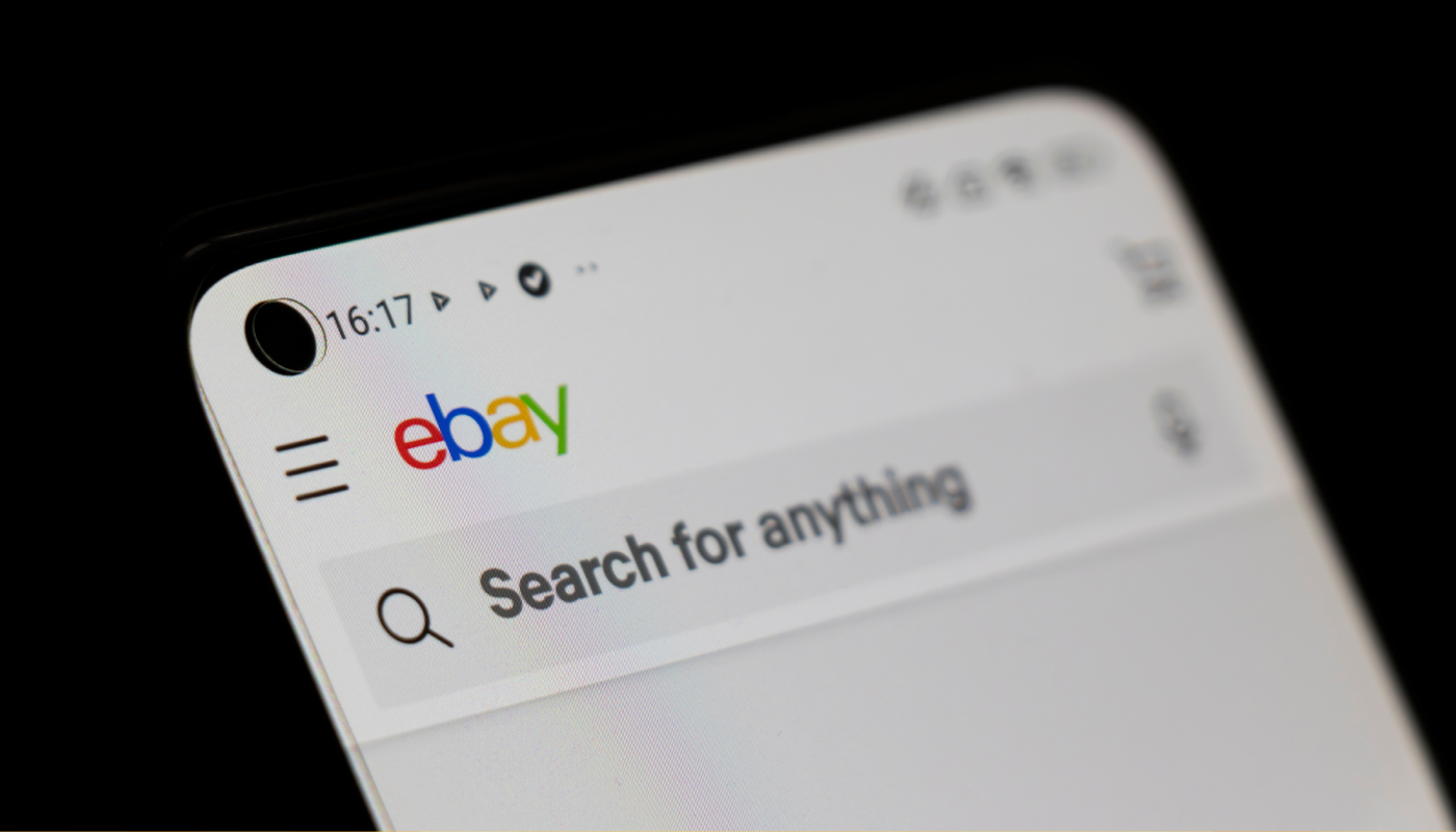 A mobile phone with the eBay website loaded.