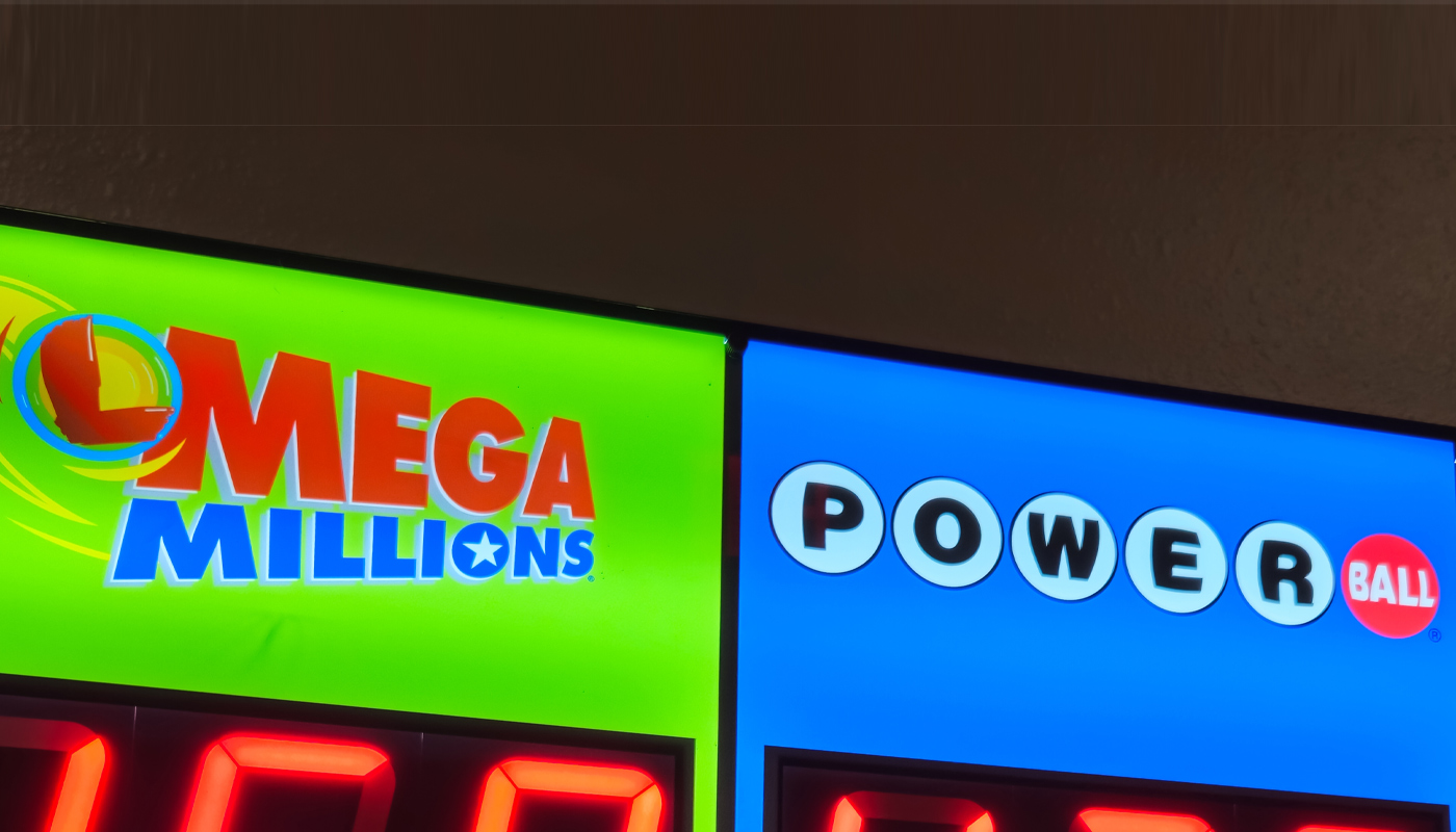 A sign with the Mega Millions and Powerball logos, at a lottery retailer.